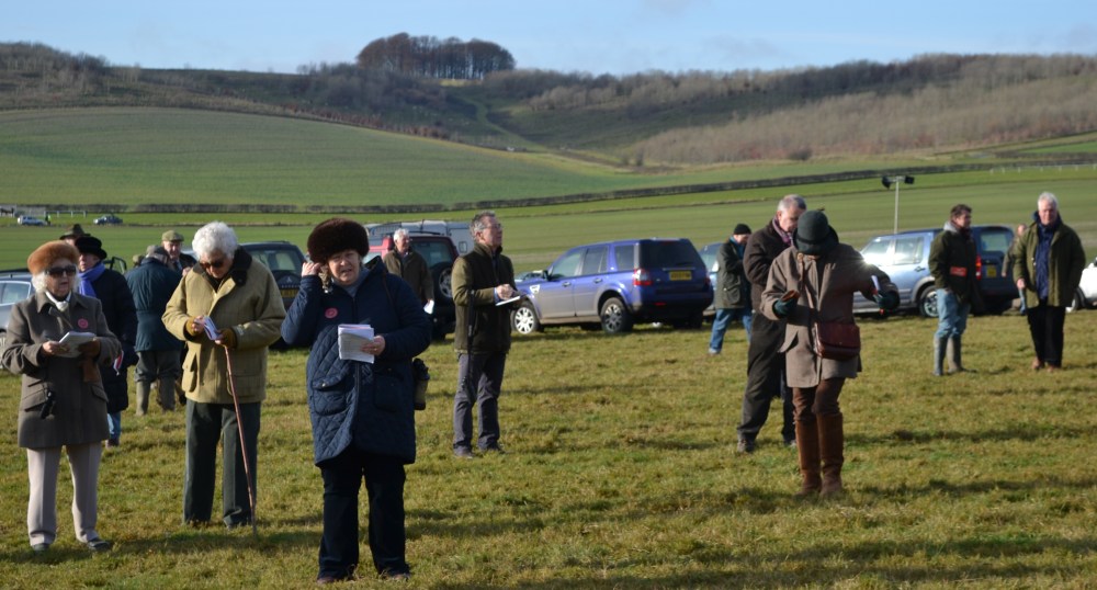 A very familiar figure (centre, glasses) is studying the betting from a distance, it's Point-to-Point Authority Chairman, Simon Claisse