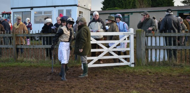 Ally Stirling (light blue silks with maroon seams) chuckles as Jane negotiates the mud