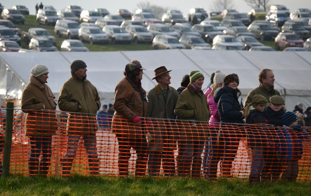 Cherry Coward (brown jacket & coloured cap) looks on as 15 year old Amicelli makes his comeback from injury