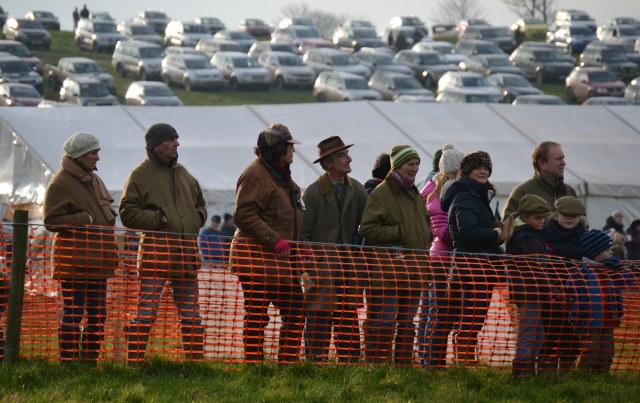 Cherry Coward (brown jacket & coloured cap) looks on as 15 year old Amicelli makes his comeback from injury