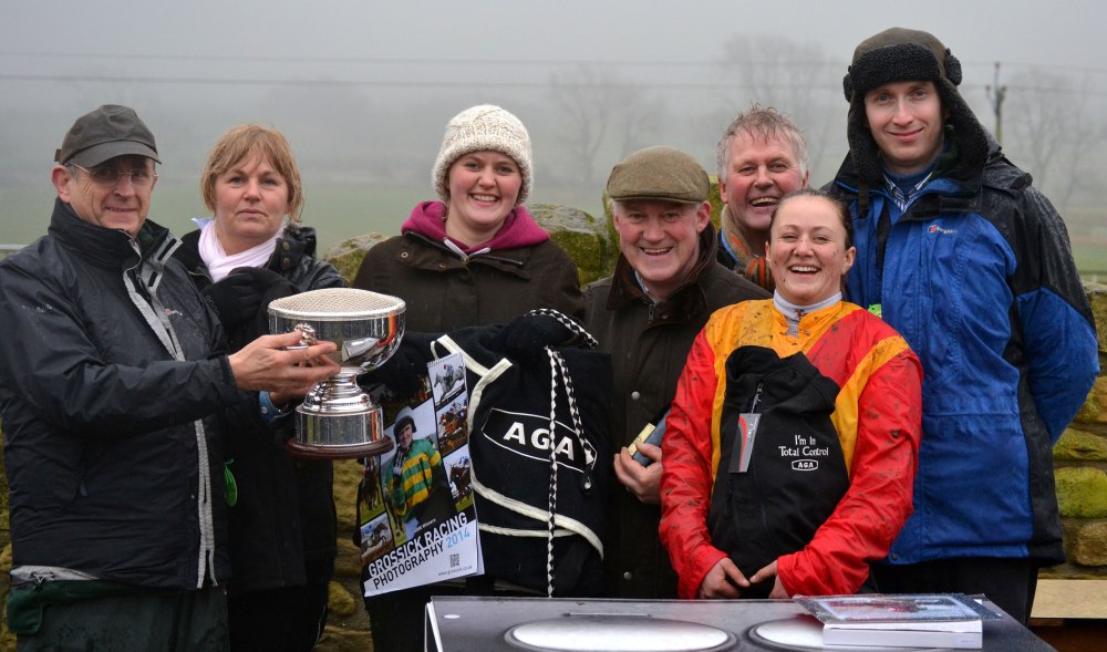 Ron Lillie (far left) and Grant Lillie (far right) of AGA present trophies to the winning connections following the AGA Ladies Open race at Alnwick, which was won by Sacred Mountain (Catherine Walton), also in the photo are L-R: Claire Walton (Catherines mam), Charlotte Walton (Catherine's sister), Jimmy Walton (owner/trainer) and Frankie Walton (owner)