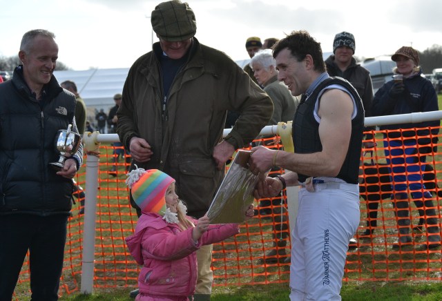 Xaviera Wall presents dad Mark with a print after his win in the Mens Open