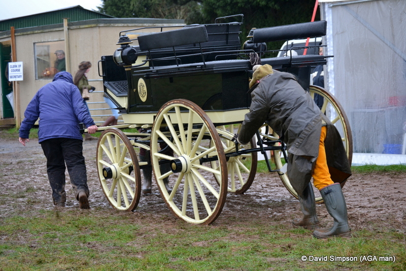 Derek Freathy helps to push the carriage off the course 