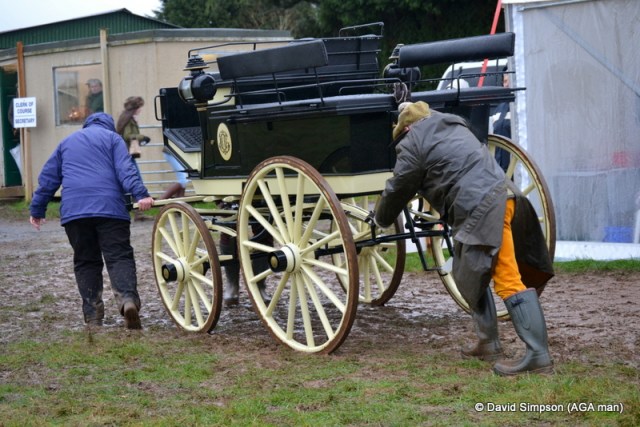 Derek Freathy helps to push the carriage off the course 