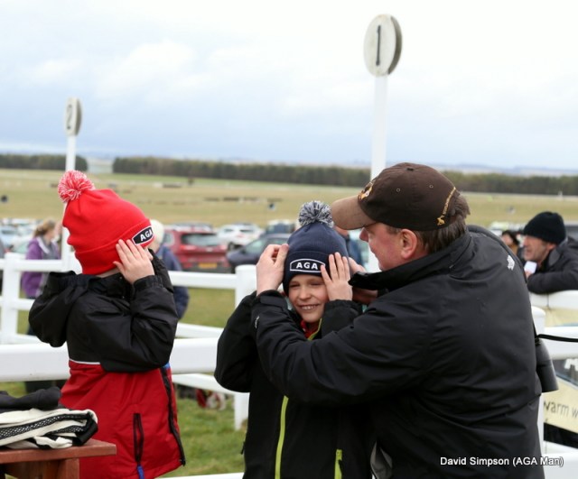 The boys ensure that the AGA logo is facing the front on their new hats 