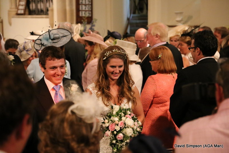 The happy couple leave the church, although the monsoon outside ensured that they weren't gone for long!